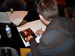 Jeff Jenkins signing a copy of his print